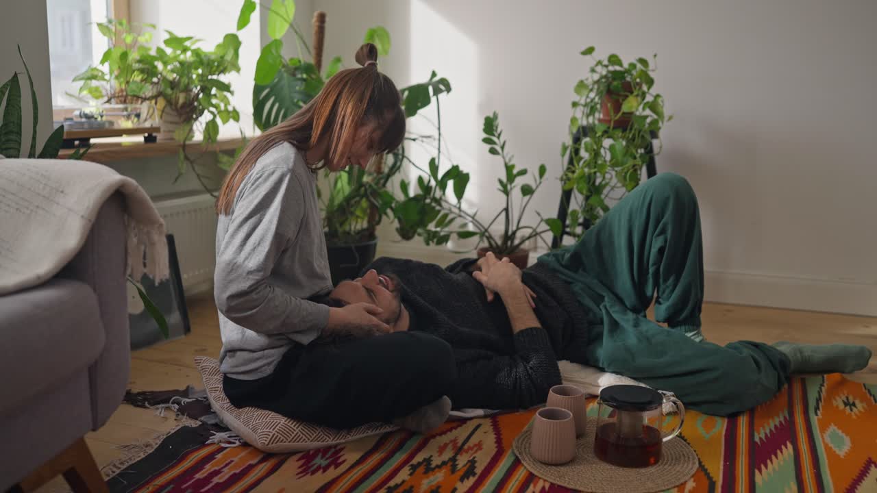 Couple Relaxing Indoors Surrounded by Plants