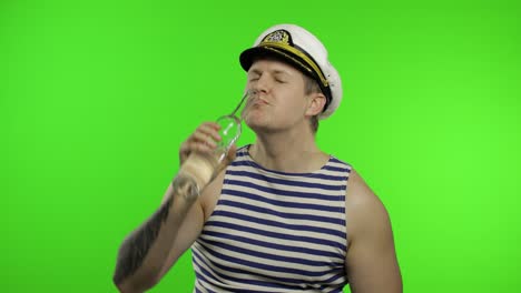 young sailor man drinks vodka. seaman guy in sailor's vest shirt. chroma key