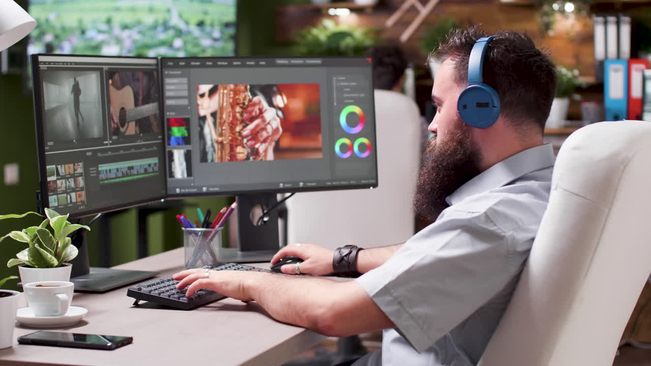 Man working on video editing with dual monitors