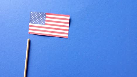 national flag of usa and stick lying on blue background with copy space