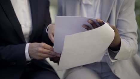 front view of two women holding documents