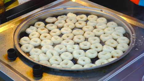 traditional turkish dessert. it is called "lokma". delicious and authentic street food. special for ramadan. chef is preparing lokma  desserts to eat for people.