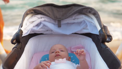 Baby-girl-in-pram-at-the-seaside