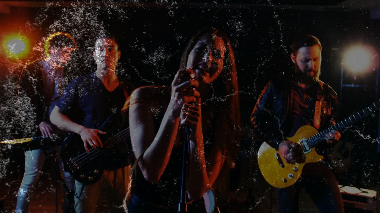 Vertical video: Singing vocalist in black top with band starting, leaning into vintage mic on stage