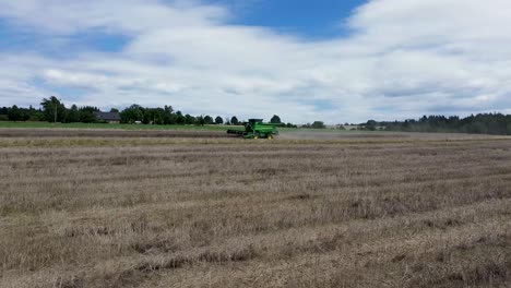 a view of efficient combined harvesting in action when the camera from the drone and rotates around it