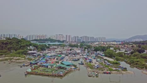 a dynamic tilting aerial footage of the fishing village in lau fau shan in the new territories of hong kong