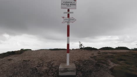 Tilt-up-camera-movement-reveals-the-Piatra-Mare-peak-board-at-an-altitude-of-1844-meters-above-sea-level-in-the-Romanian-Carpathian-Mountains