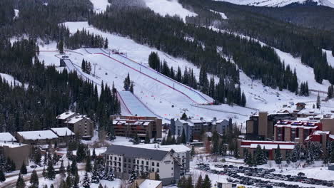 parking lot half pipe big air jump ski snowboard gondola ski lift aerial drone cinematic copper mountain base colorado winter december christmas ski runs trails landscape rocky mountains circle right