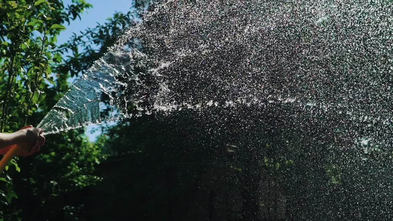 Watering the green grass, close up. Slow Motion