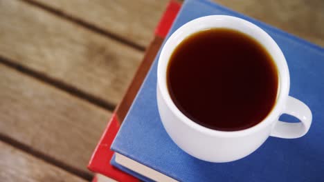 black coffee on book stack 4k