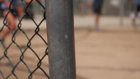 chain link fence with people in the background