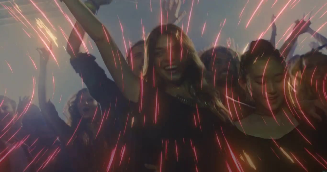 Lead woman raising arms, sparking red streak overlay and pulsing lights, group celebrating music