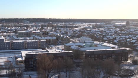 aerial view of snow covered rooftops and buildings in orebro city, sweden