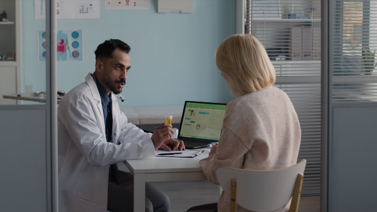 Doctor consulting with elderly patient in clinical setting