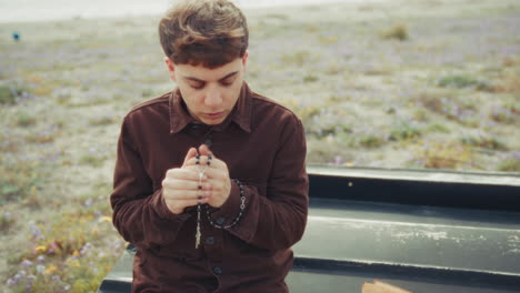 intense moment of prayer for a christian man on the beach