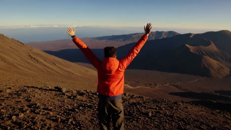 person on a mountain top enjoying the view