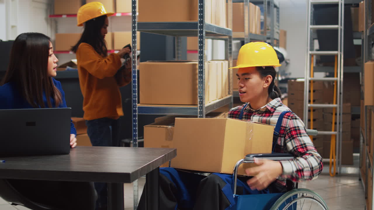 Warehouse employee in wheelchair holding box