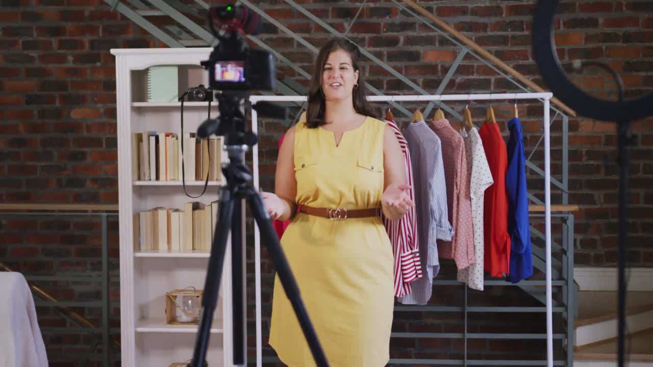 Una vlogger donna caucasica che realizza un video di moda a casa.