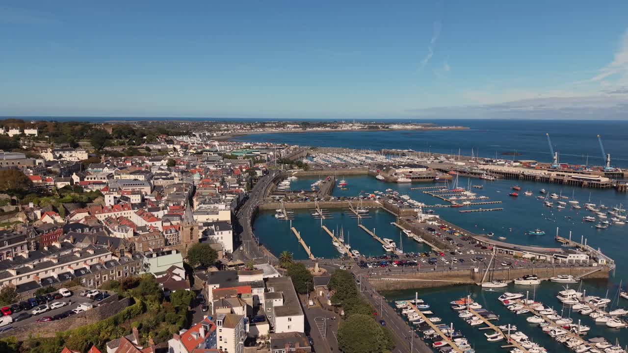 Flight St Peter Port Harbour Guernsey from Albert marina over Victoria Marina north to QEII Marina and Salerie Corner on sunny day with blue sky calm sea views over Belle Greve Bay towards St Sampson
