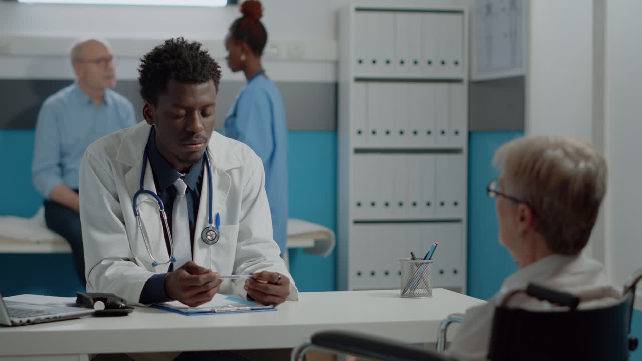 Doctor consulting with elderly patient in clinic