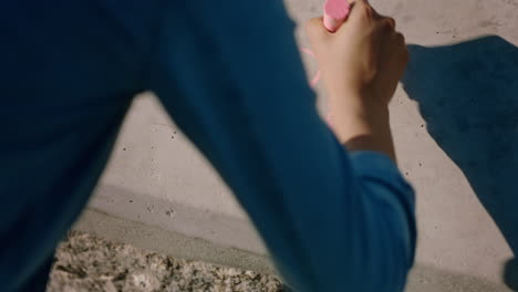 woman-hand-using-pink-chalk-writing-happiness-on-ground-teenage-girl-enjoying-creativity