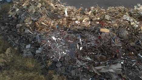 aerial flyover of dumped wood at a trash waste junkyard, global warming and environmental issue