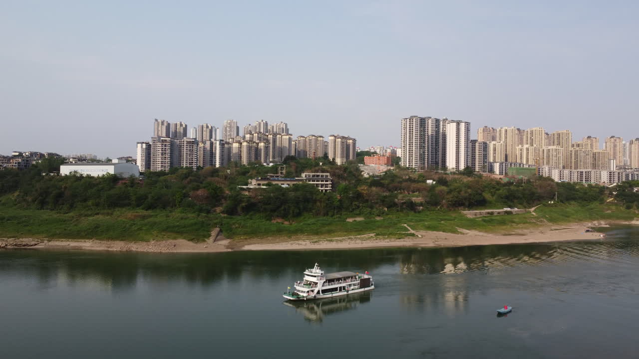 A yacht full of tourists is driving on the river