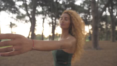 beautiful girl with ring on finger reaching out in gesture in the peaceful woods of centennial parklands - sydney australia - close up shot