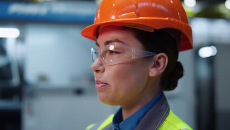 Cheerful-woman-mechanic-laughing-at-special-huge-modern-digital-warehouse.