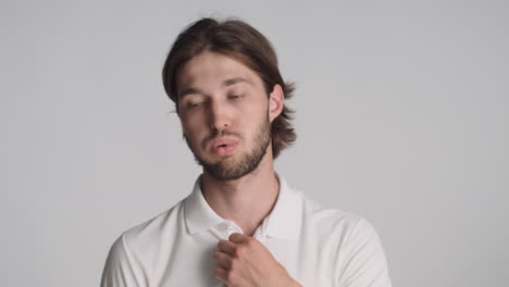 Caucasian-man-in-front-of-camera-on-gray-background.