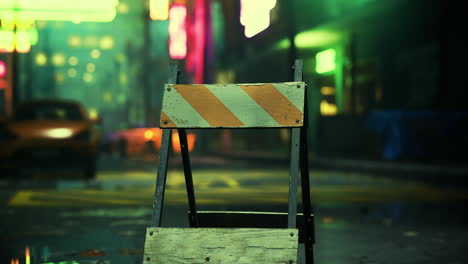 construction barrier blocking a deserted urban street at night in neon light
