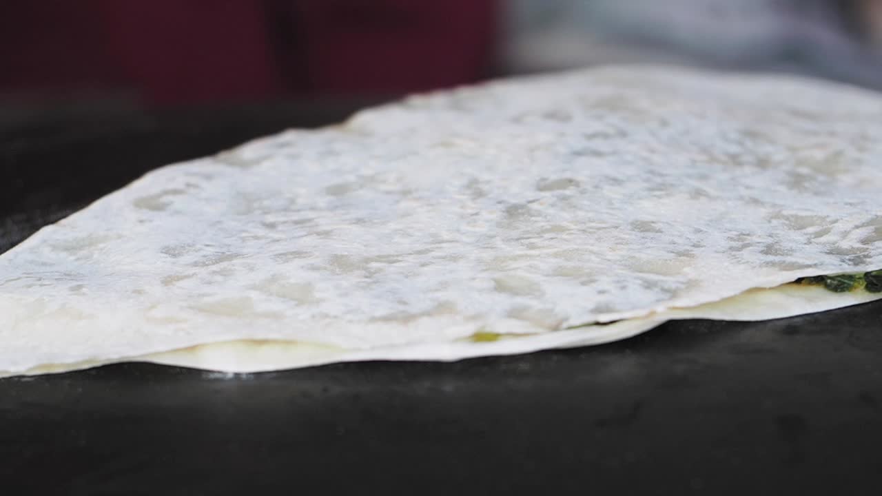 Spinach crepe on a black surface
