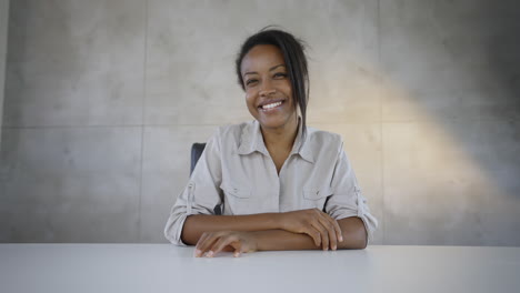 happy woman sitting at a table