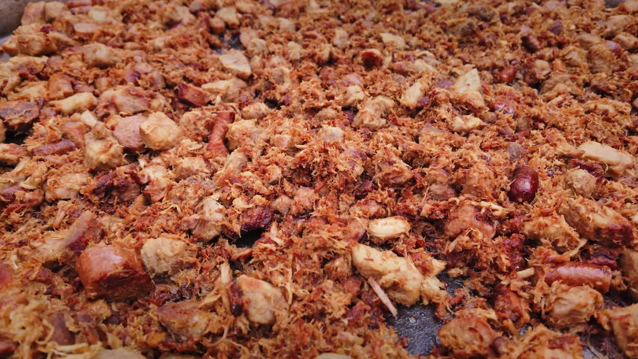 Pork meat mix and sausages cook in large pan at food festival CLOSE-UP