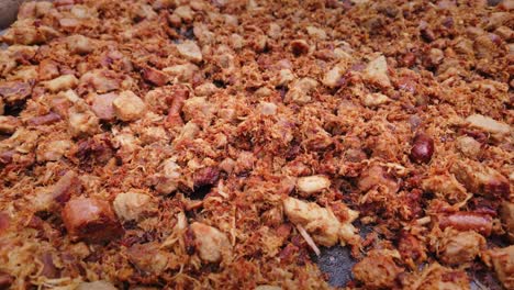 pork meat mix and sausages cook in large pan at food festival close-up