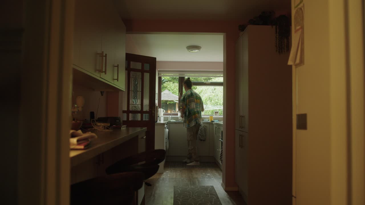 Man walking into the kitchen to make a cup of tea