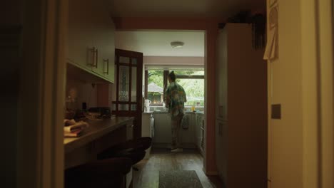 man walking into the kitchen to make a cup of tea