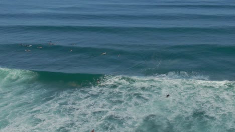 Aerial-view-of-Paddle-boarder-catching-a-wave-at-Laniakea-beach