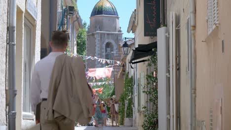 slowmotion tilting shot of a well-dressed man walking down the streets of montpellier