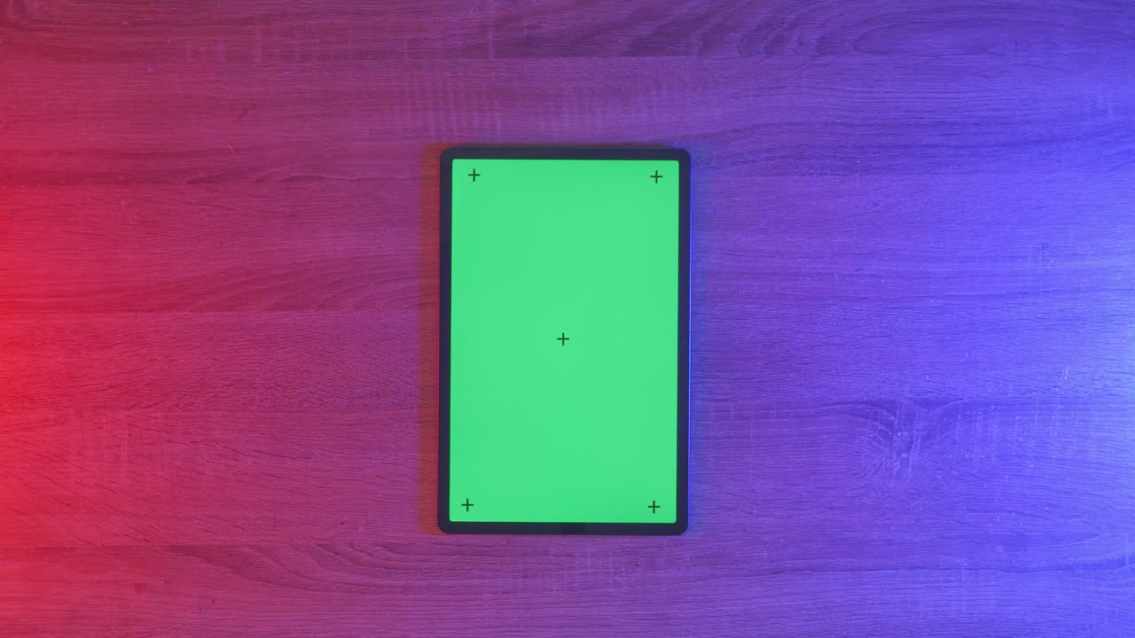 Tablet with Green Screen on Wooden Surface