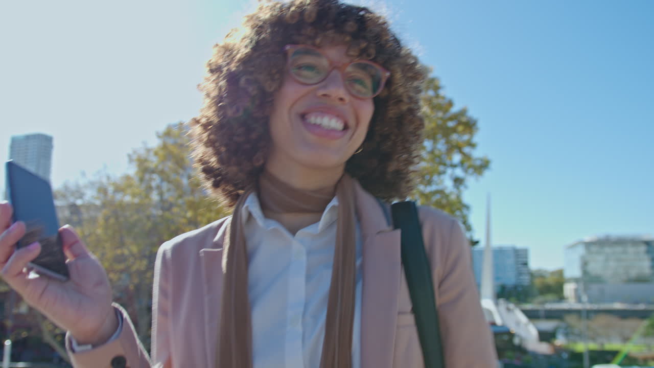 Carefree African-American Businesswoman Dancing Outdoors After Work