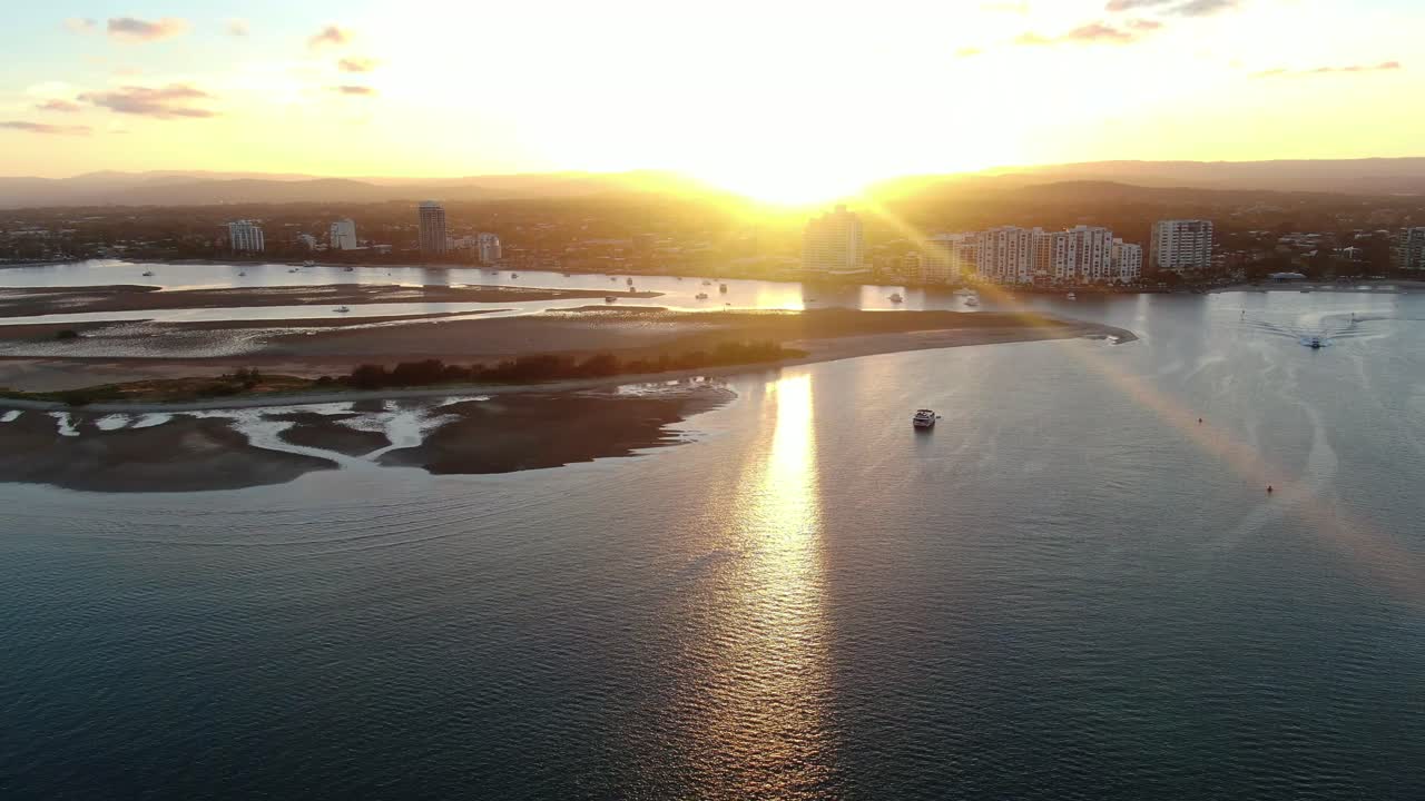 Sunset Gold Coast waterways, pull back over suns reflection on water