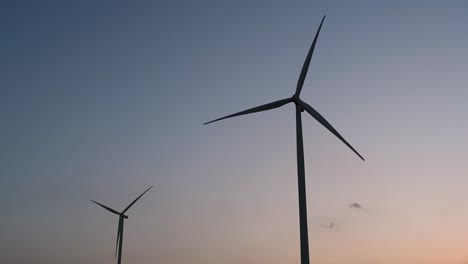 Wind-Turbines-Silhouette-against-the-Blue-sky-during-Sunset,-clean-alternative-energy-in-Thailand-and-mainland-Southeast-Asia