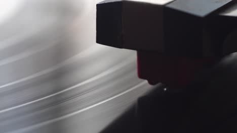 spinning vinyl record and gramophone needle, close up