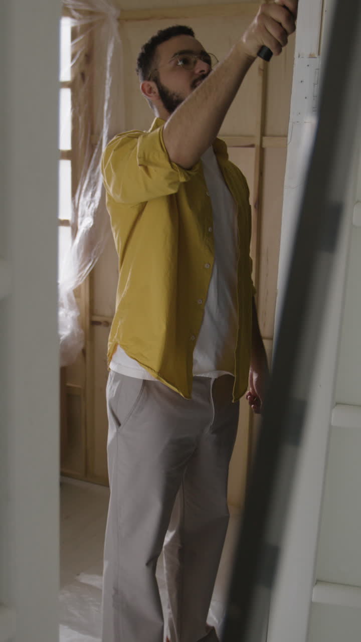 Man painting door during renovation