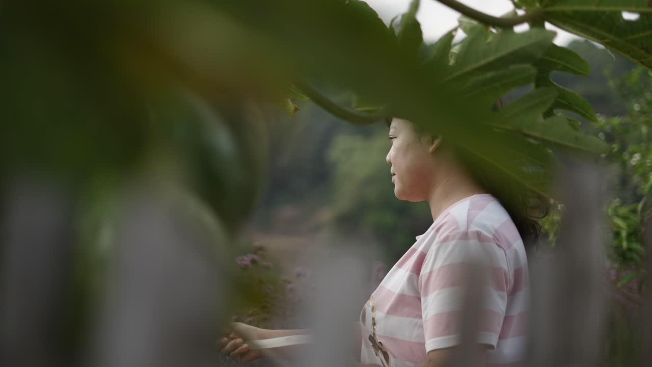 Woman in a garden surrounded by plants