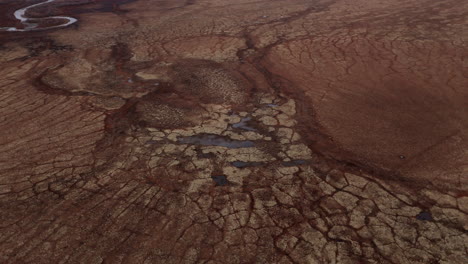 rugged soil texture near ogilvie mountain in yukon territory, canada. aerial orbiting shot