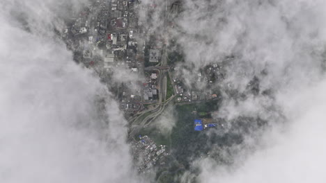 bogota colombia aerial v9 high altitude vertical drone flyover la paz hillside capturing satellite view across alameda and santa fe through white clouds - shot with mavic 3 cine - november 2022