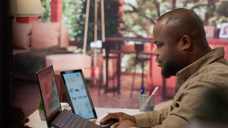 entrepreneur reviews business updates and details at his home