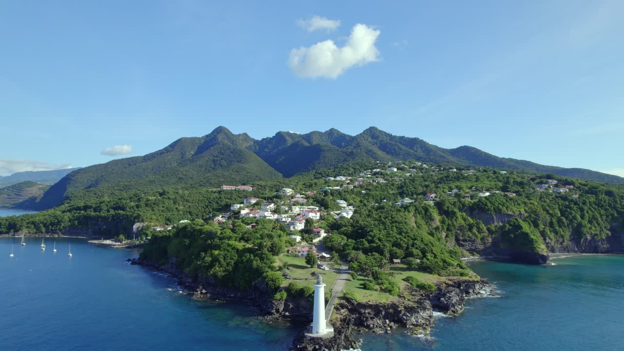 Drone flying towards lighthouse at Vieux-Fort with beautiful landscape in background, Guadeloupe